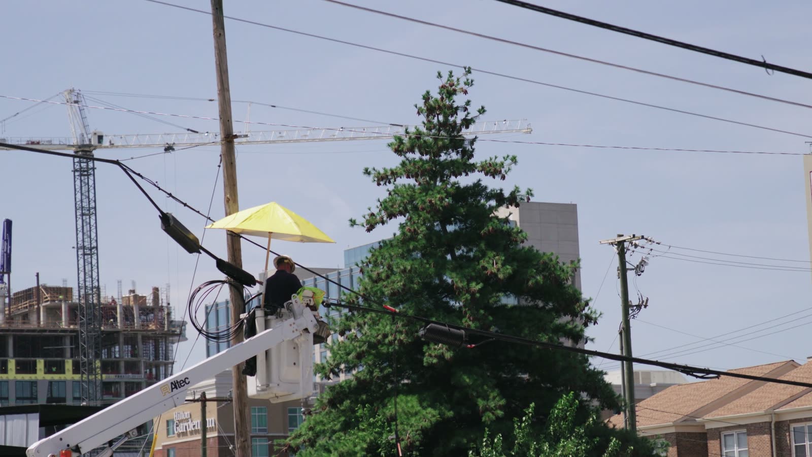 Electrician in a lift working on main power lines